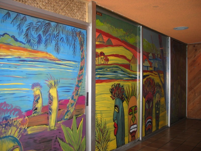 The glass doors of the Outrigger room have been painted in a Tiki mural.