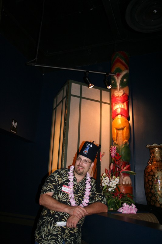 Johnny models with a happy, though painted, Tiki pole.