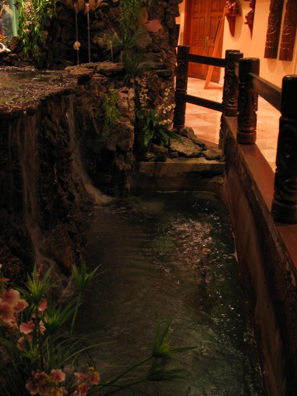 Around the base of the Tiki water garden is an intact Tiki rail.