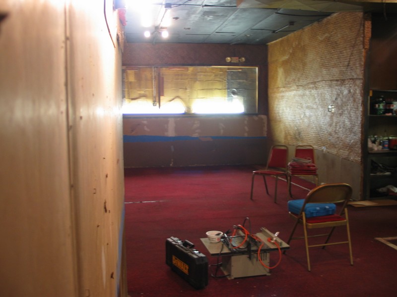 Looking from the back room towards the area near the bar, with the entrance to the kitchen on the right.