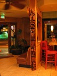 Having now entered, looking back out the front door. Tiki poles such as this are utilized as room dividers. In this picture, the bar area is to the right.