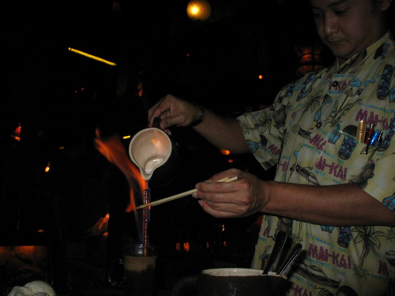 Yes, they use chopsticks to hold the cinnamon sticks that they use to pour down and help guide the flaming coffee into the mug with.