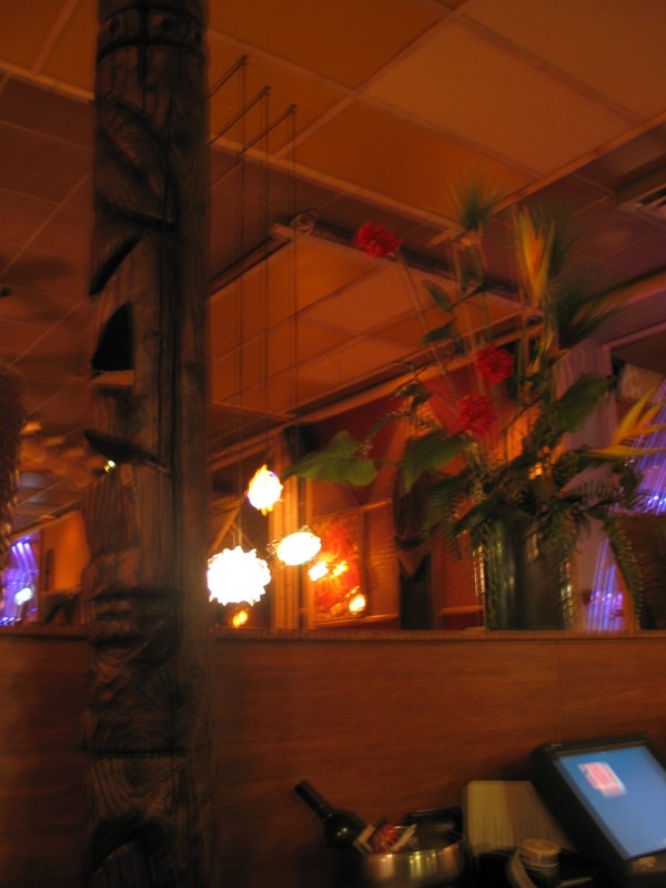 Tikis scowled down at dinners, and tropical flower arrangements added to the feel.