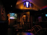 After entering, looking back at the area above the door, is the most wonderful purple neon Tiki EVER!