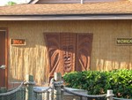 a closer picture of the carving and some of the signage on the side of the hut.