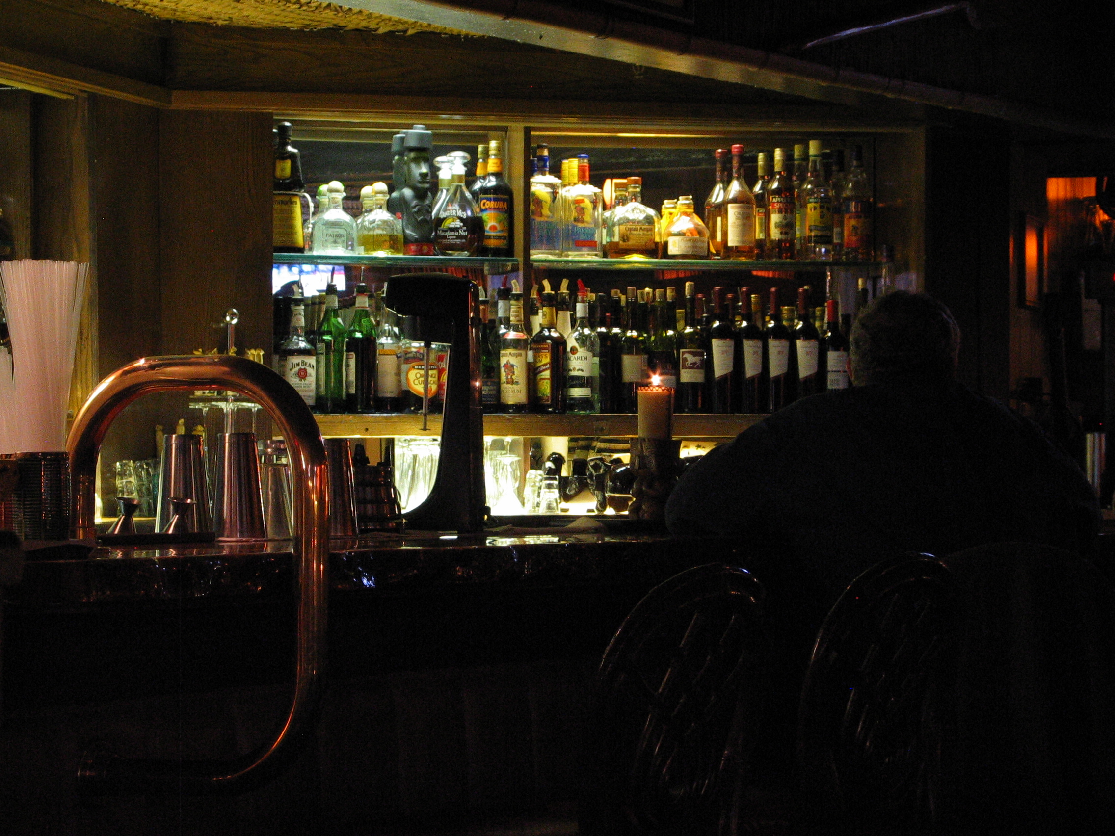 Bottles at the bar. The Pisco Moai bottle is in the upper left compartment.