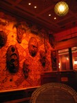 more masks with a glipse of the top of a peacock throne.